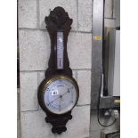 An oak barometer by Barrow & Clark, Boston and one other.