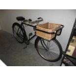 A vintage Raleigh bicycle with basket.