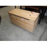 A small pine blanket box.