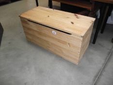 A small pine blanket box.