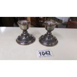 A pair of hall marked silver candlesticks.