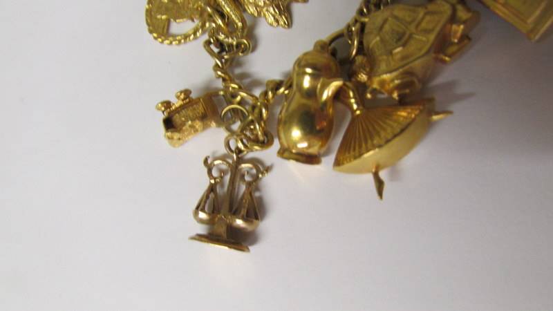 A 9ct gold charm bracelet with charms, 34 grams. (re-entered due to non paying bidder). - Image 4 of 4