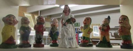 A set of vintage Snow White and the Seven Dwarfs garden ornaments.