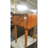 A pale mahogany 2 drawer drop side occasional table.