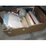 A box of fabric, haberdashery items and sewing/textile books.