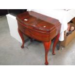 A dark wood stained side table with lift up lid.