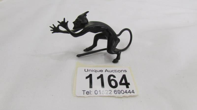 A miniature iron figure of Satan.