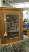 An oak corner cupboard.