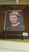 An oak framed portrait of a child.