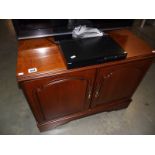 A dark wood stained 2 door cupboard/television stand.