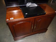 A dark wood stained 2 door cupboard/television stand.