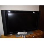 A Phillips flat screen tv with remote