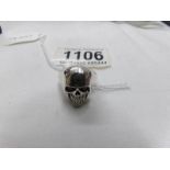A silver skull ring with red eyes. Marked 925, size O.