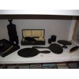 A quantity of mid 20th century ebony dressing table set and other items.