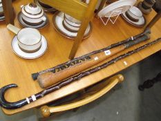 2 wooden canes and a baseball bat.