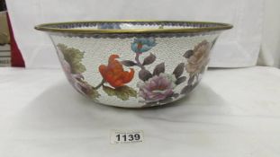 A large Cloissonne bowl decorated with flowers and butterflies.