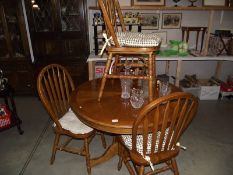 An oak dining table and 4 chairs.