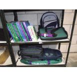 2 shelves of Wimbledon books, holdalls and back packs etc.