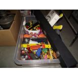 A box containing diecast cars including Corgi, lesney, and a tambourine, maracas, drumsticks etc.