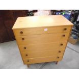 A teak veneered chest of drawers.