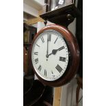 A circular mahogany wall clock.