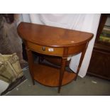 A light mahogany finished D end hall table with drawer and shelf.