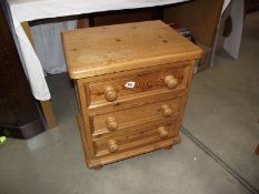 A solid pine three drawer bedroom chest.