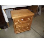 A solid pine three drawer bedroom chest.