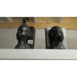 A pair of native head book ends.