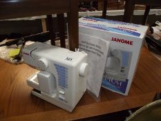 A boxed Janome mini sewing machine.