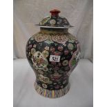 A large oriental lidded pottery urn.