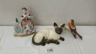 A Royal Doulton Siamese cat, a Goebel robin on branch and a lady at dressing table.