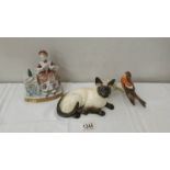 A Royal Doulton Siamese cat, a Goebel robin on branch and a lady at dressing table.