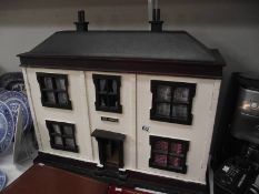 A vintage wooden dolls house 'The Mews' with furniture