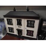 A vintage wooden dolls house 'The Mews' with furniture