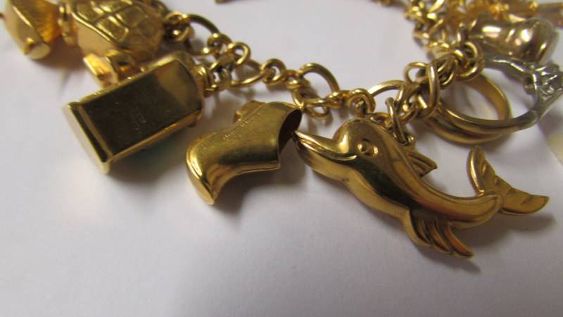 A 9ct gold charm bracelet with charms, 34 grams. (re-entered due to non paying bidder). - Image 2 of 4