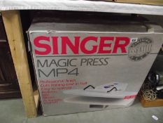 A boxed Singer magic press MP4