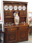 A solid oak dresser with carved rose pattern doors