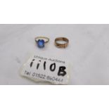 A 9ct gold ring set blue stone, size L and a 9ct gold buckle ring, size J.