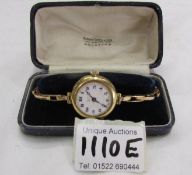 A vintage ladies 18ct gold wristwatch on a 9ct gold bracelet.