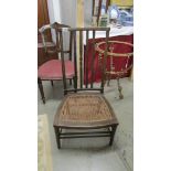 A cane seated nursing chair.