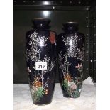 A pair of hand painted metal vases, (one a/f).