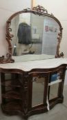 A Victorian mahogany credenza with marble top and mirror back.