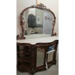 A Victorian mahogany credenza with marble top and mirror back.