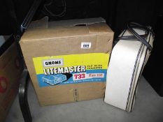 A boxed Gnome Litemaster 733 slide projector