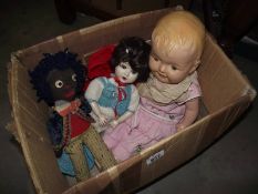 A box of 3 vintage dolls being a vintage golly, china doll and one other.