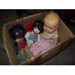 A box of 3 vintage dolls being a vintage golly, china doll and one other.