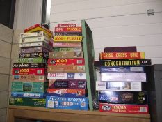 A large quantity of jigsaw puzzles (some still sealed) including old games and bagatelle.