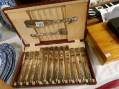 A cased set of silver handled fish knives and forks with servers.