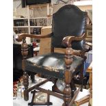 An early 20th century oak carver chair with green leather seat
